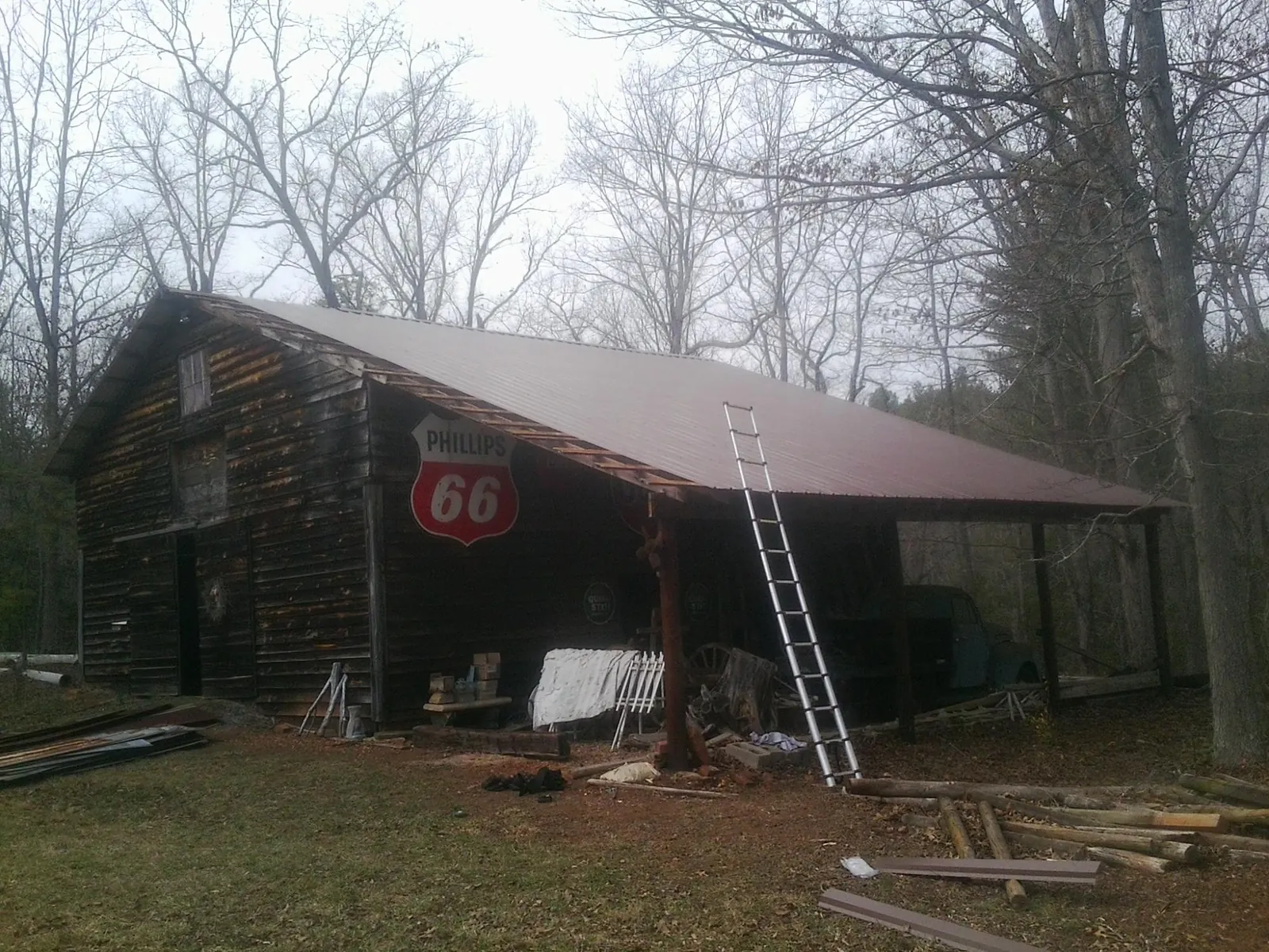 New metal roof on an open sided timber barn with a vintage sign in Three Rivers